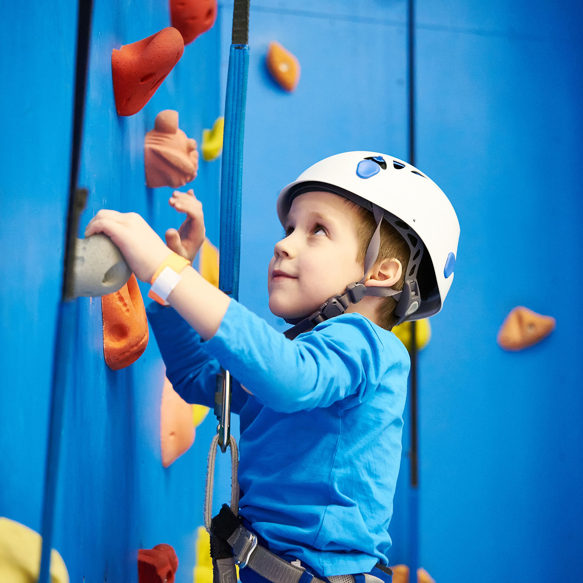 boy looking st climbing wall