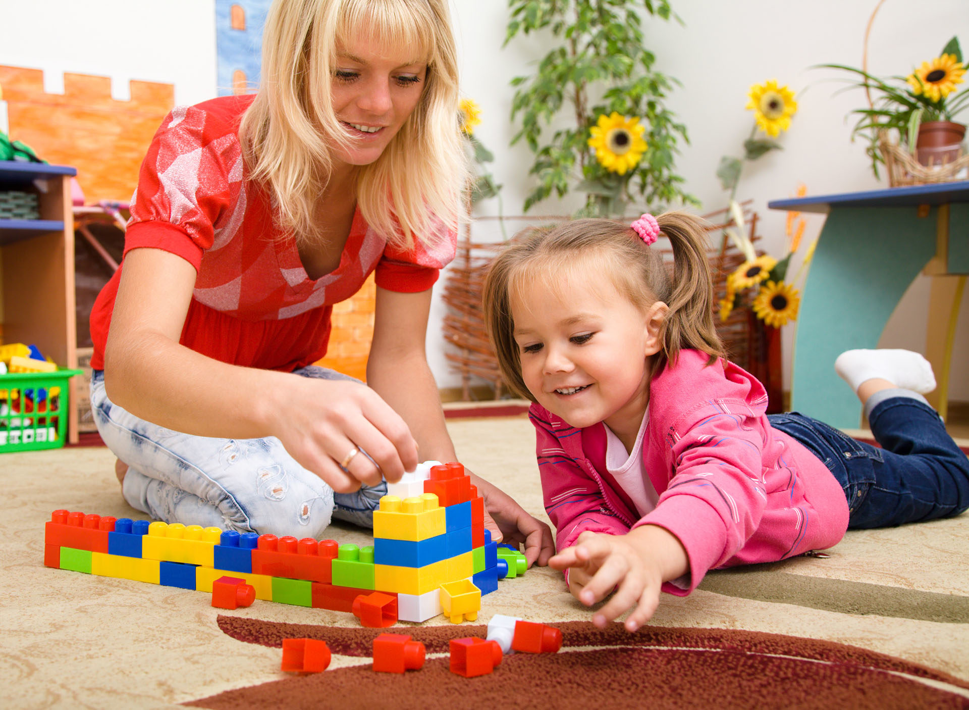 woman and girl with building blocks