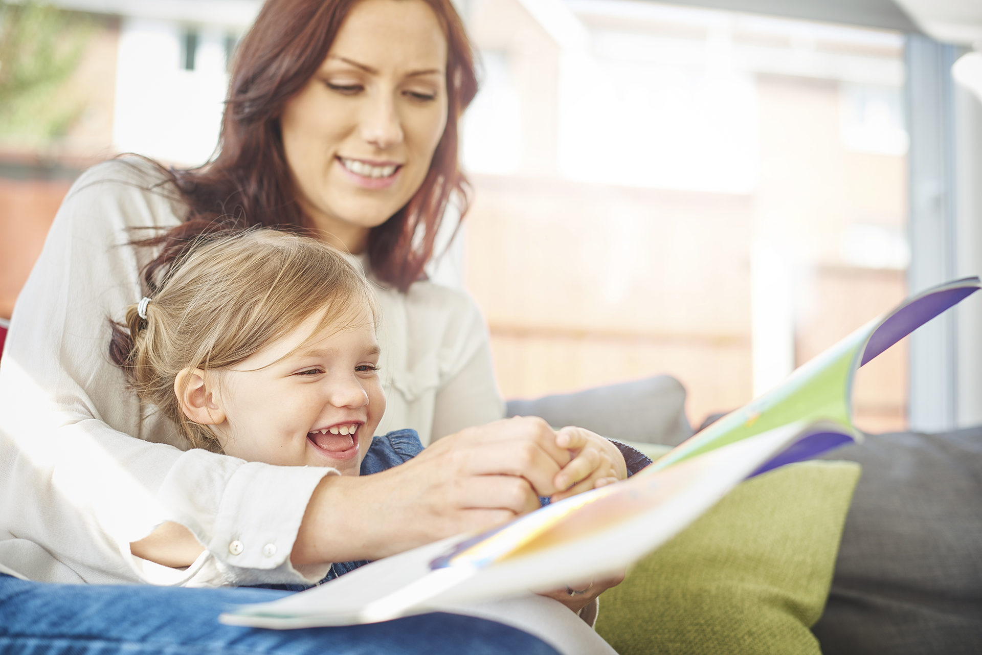 woman reading story to girl