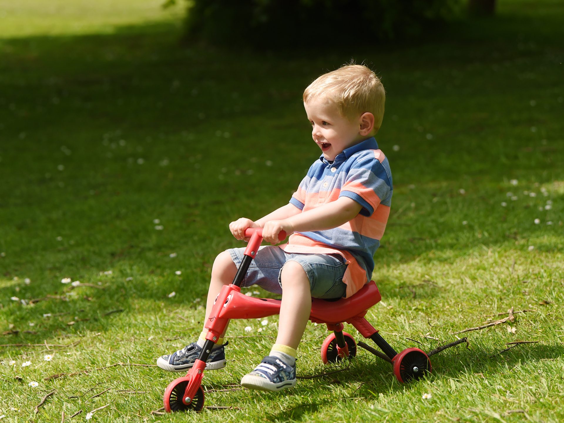 Young child playing on a scooter during the easter holidays