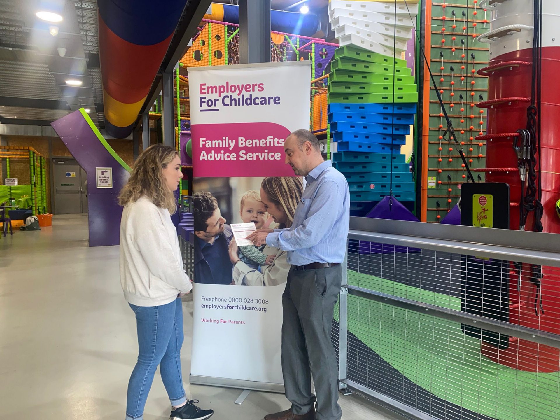 Parent receiving advice on childcare support from Jimmy Gallagher, Family Benefits Advice Service in High Rise adventure centre Lisburn