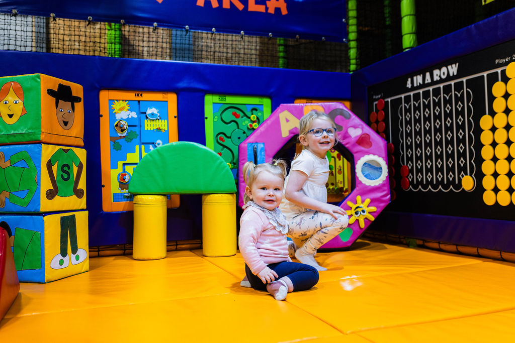 Little girls playing in the bright and colourful soft play area at High Rise Lisburn
